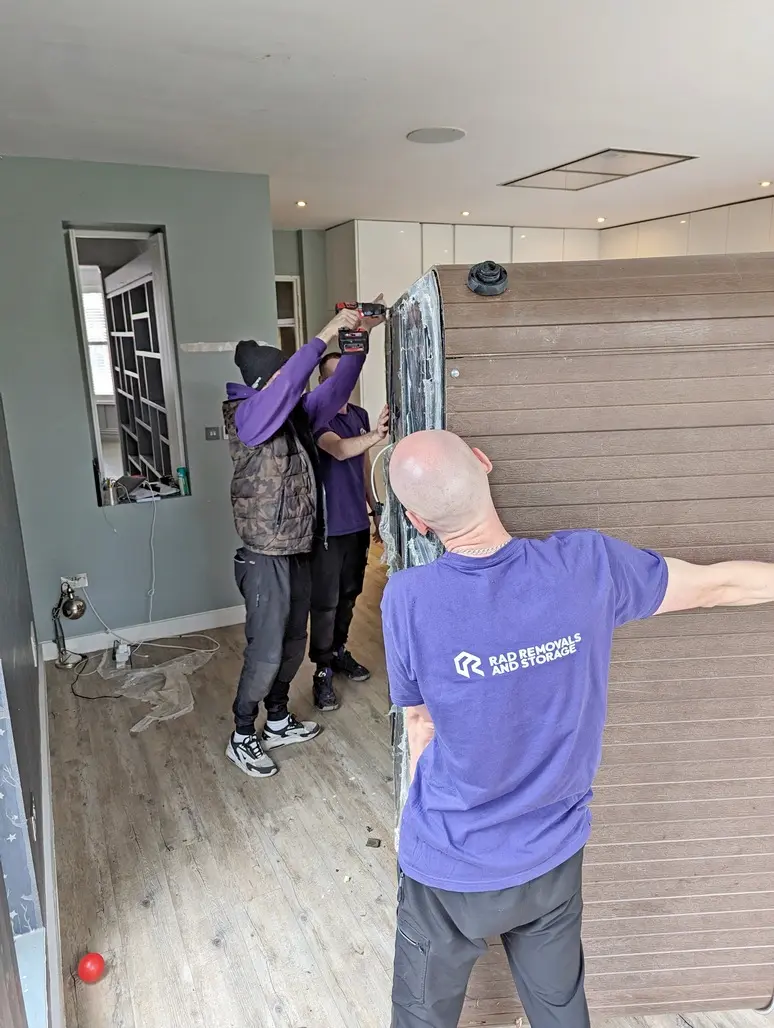 RAD Removals team disassembling a jacuzzi in a residential garden in Acton, West London